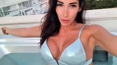 Busty curly brunette with big boobs fucks on couch